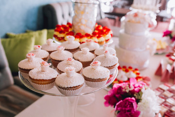 Delicious wedding reception candy bar dessert table. For a party. Ombre cake, cupcakes, sweetness and flowers