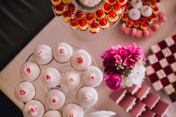 Delicious wedding reception candy bar dessert table. For a party. Ombre cake, cupcakes, sweetness and flowers