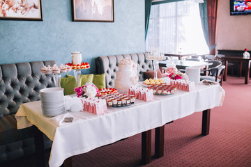 Delicious wedding reception candy bar dessert table. For a party. Ombre cake, cupcakes, sweetness and flowers