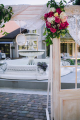 Wedding ceremony decoration. Table flowers decor. wedding arch decorated with flowers.