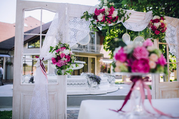 Wedding ceremony decoration. Table flowers decor. wedding arch decorated with flowers.