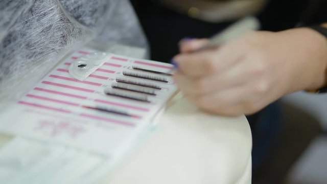 Female lashmaker work on tablet