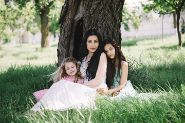 Mother with daughters outdoors in a summer walk