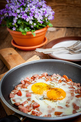 Fried eggs with chopped sausage.