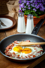 Fried eggs with chopped sausage.