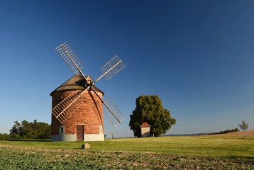 Fototapeta premium Beautiful old windmill and landscape with the sunset. Chvalkovice - Czech Republic. Europe.