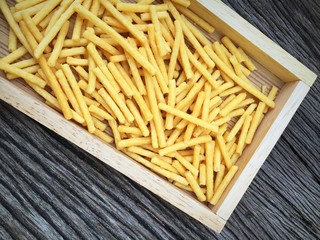 French-fries with ketchup on wood box