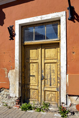 Old wooden door with peeling paint in the town of Tallinn