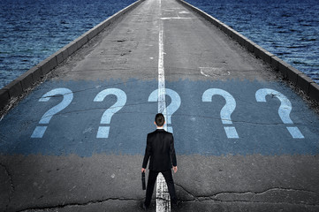 Question marks message on road