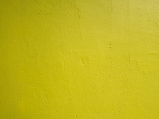 Closeup on abstract vintage grunge texture of yellow cement wall for background or layout design.