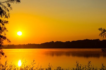 Sunrise on a fog covered lake