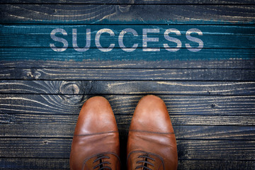 Success message and business shoes