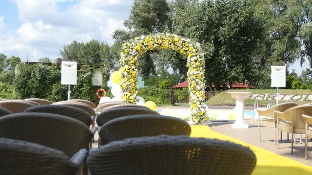 Arch with fresh yellow and white flowers for wedding ceremony