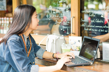 Hipster indy woman using laptop for communications social networ