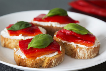 Canapes with roasted peppers, cream cheese and basil