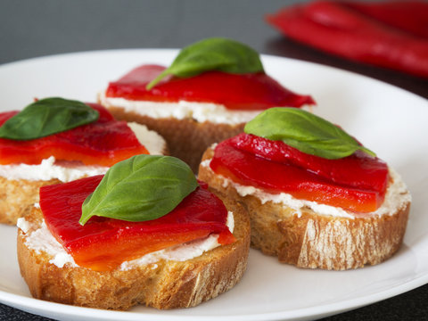Canapes with roasted peppers, cream cheese and basil