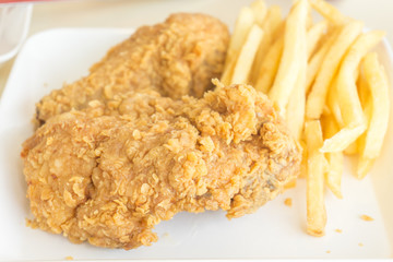 fried chicken and french fries on white dish