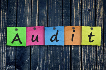 Audit message post on wooden wall