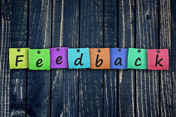 Feedback message post on wooden wall