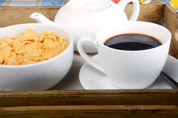 Breakfast tray with coffee and cereals.