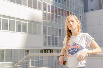 beautiful slim girl in shorts and t-shirt standing on bolkone looking into the distance