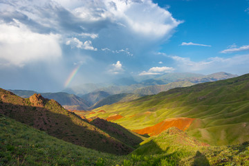 Beautiful mountain landscape with bright rainbow, Kyrgyzstan.