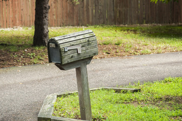 American outdoor wooden mailbox on wooden support
