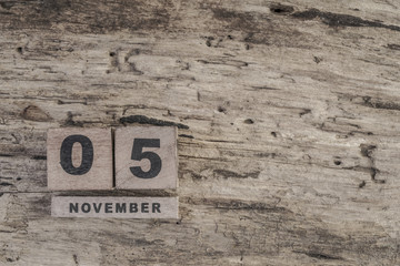 cube calendar for november on wooden surface with copy space