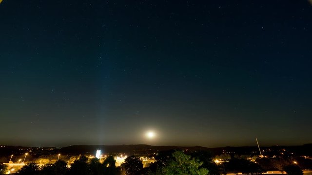 moon and stars on black night sky time lapse