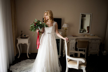 Fototapeta premium Amazing bride with her bouquet is waiting her groom