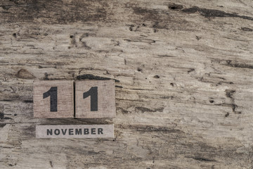 cube calendar for november on wooden surface with copy space