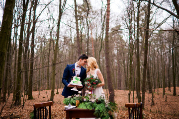 Romantic and happy wedding couple in autumn forest