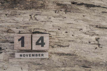 cube calendar for november on wooden surface with copy space