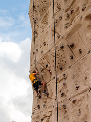 girl climbing wall at outdoor fair