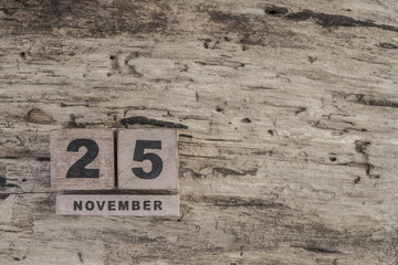 cube calendar for november on wooden surface with copy space