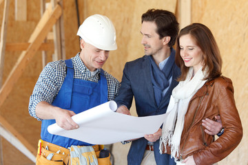 Worker shows house design plans
