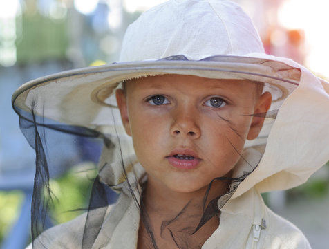 Portrait of a little boy beekeeper