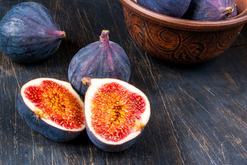 Ripe raw figs on a black wooden table