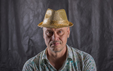 portrait of a man in a yellow hat in the studio