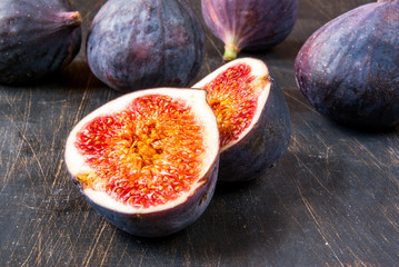 Ripe raw figs on a black wooden table