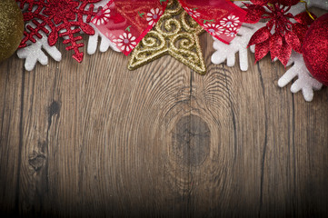 Christmas frame with stars, snow and christmas balls on wood table