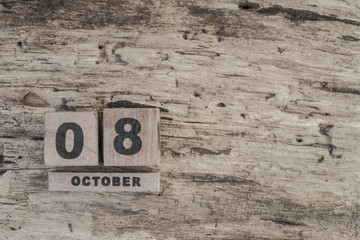 Cube calendar for october on wooden background with copy space