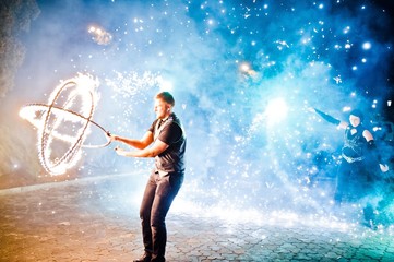 Presentable and awesome fire show at evening on wedding party.Photo with some noice