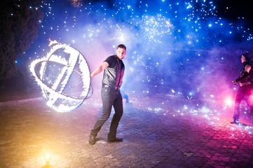 Presentable and awesome fire show at evening on wedding party.Photo with some noice