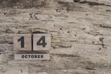 Cube calendar for october on wooden background with copy space