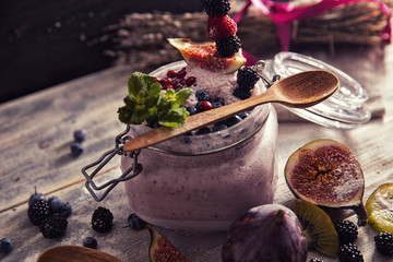 bright detox smoothie with berries on wooden background bowl