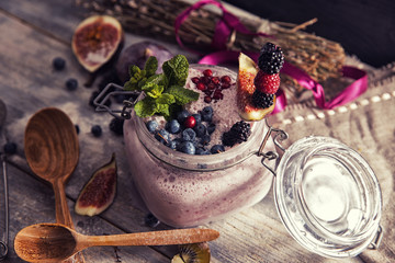 bright detox smoothie with berries on wooden background bowl