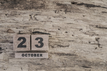 Cube calendar for october on wooden background with copy space
