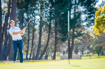 golfer playing a chip shot onto the green