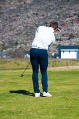 golfer playing a chip shot onto the green